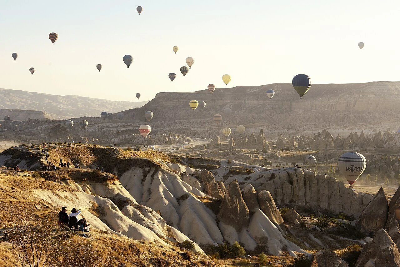 Sunrise and hot air balloons in Göreme Valley.